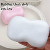 A white building block style squishy fidget toy is shown on a plate.