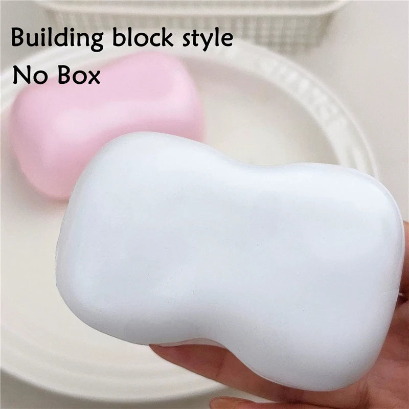 A white building block style squishy fidget toy is shown on a plate.