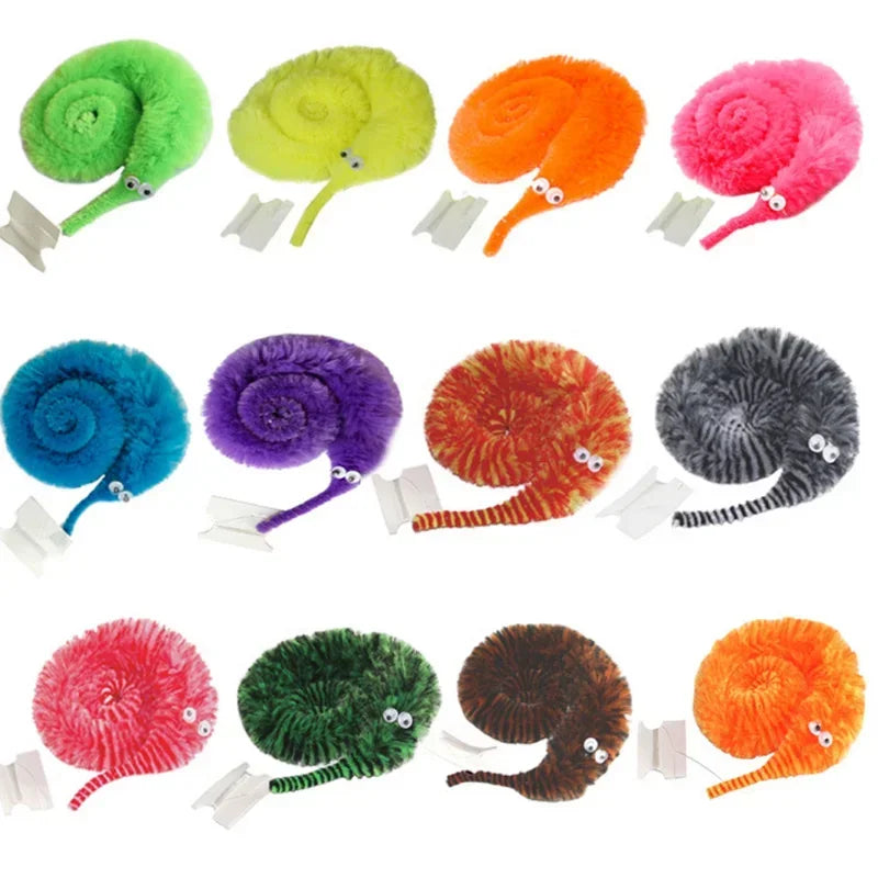 A collection of colorful magic worms on strings, including green, yellow, orange, pink, blue, purple, and gray varieties.