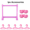 A set of pink doll laundry accessories including a drying rack and various plastic hangers.