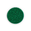 A clear container filled with small, round, green glass seed beads for jewelry making.