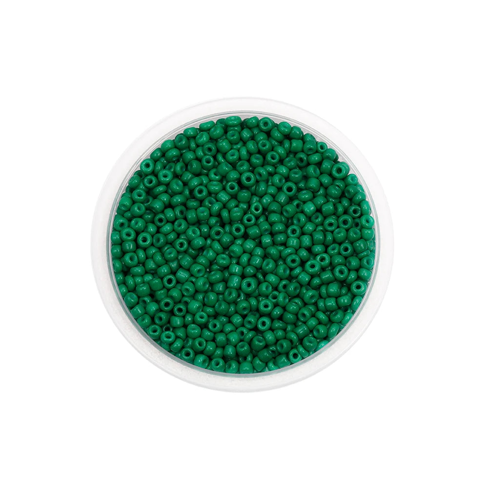 A clear container filled with small, round, green glass seed beads for jewelry making.