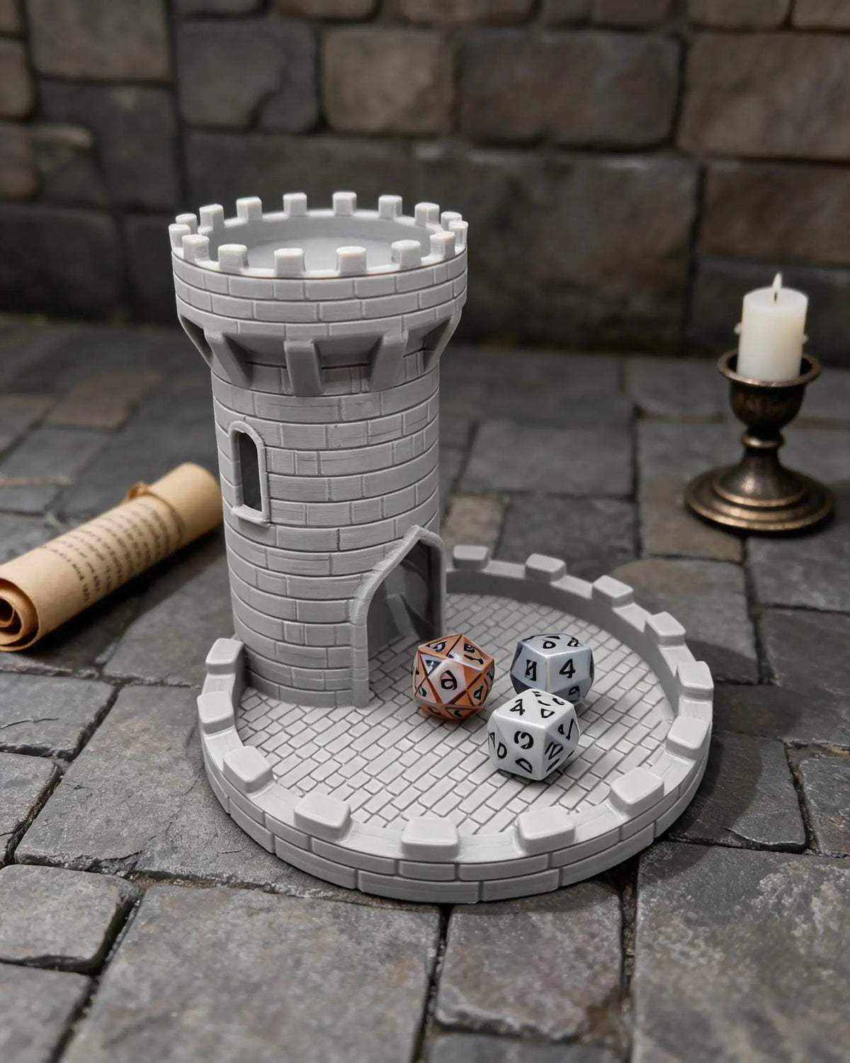 A gray medieval castle dice tower with a tray for tabletop games set on a stone surface.
