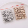 A collection of 50 plastic seashell charms, including cowrie and conch pendants, packaged for jewelry making.