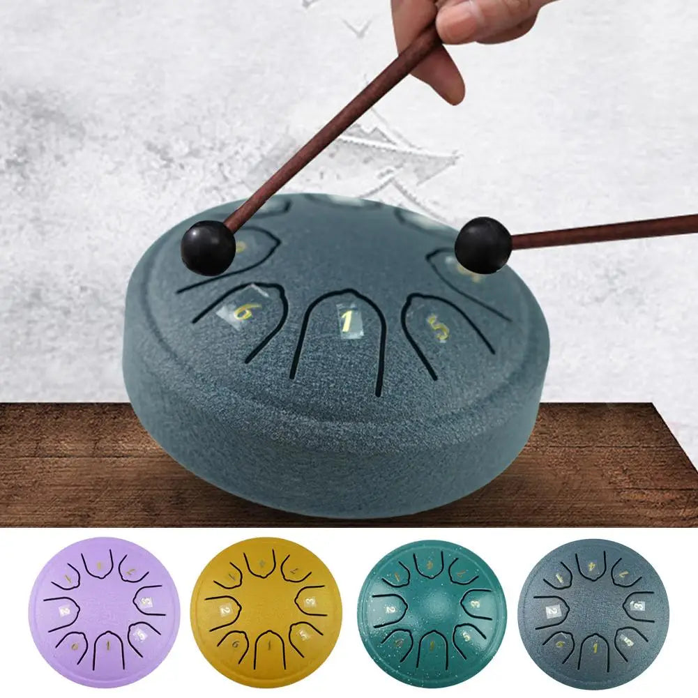 A portable steel tongue drum is shown with four color variations: purple, yellow, teal, and gray.