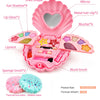 Pink princess makeup toy set featuring a shell-shaped case with mirror, various makeup products, and brushes.