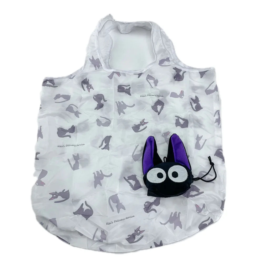 A white plush toy shaped like a hippo, featuring large black eyes and purple ears.