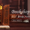 A wooden DIY book nook kit featuring an ornate facade and miniature bookshelf display.