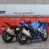 A collection of die-cast motorcycle models in red, blue, and black colors displayed on a metal surface.