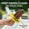 A hand holds a yellow drip-catching bowl containing a chocolate popsicle, demonstrating the product's function.