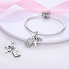 A sterling silver bracelet featuring a charm bead with a cross and a tag engraved with 'with God all things are possible'