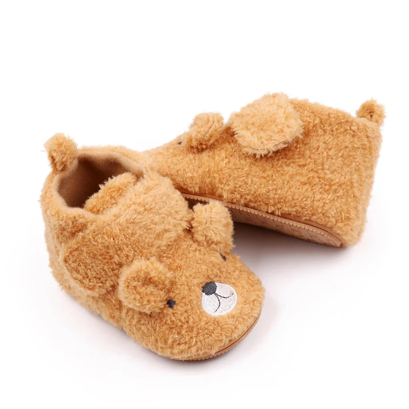 A pair of cute bear design baby prewalker shoes made of soft, fuzzy brown material.