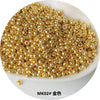A pile of small, round, gold-colored electroplated metallic glass beads for jewelry and crafting.