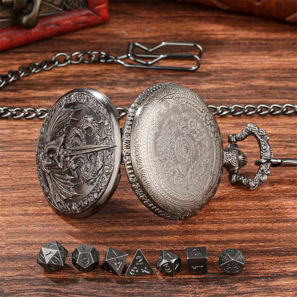 A silver steampunk dragon pocket watch dice case with seven small metal dice resting on a wooden surface.