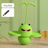 A green frog-shaped toy with a long handle is shown next to a syringe for height training and balance.
