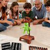 A family is playing a magnetic hangman board game with children and an adult, featuring wooden pieces.