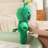Adorable green alien plush toy with long ears standing on a light green table.