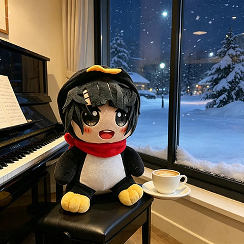 A black and white penguin plush toy with yellow accents sitting on a black surface in front of a snowy window.