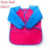 A bright pink and blue waterproof kids art and baking apron with long sleeves.