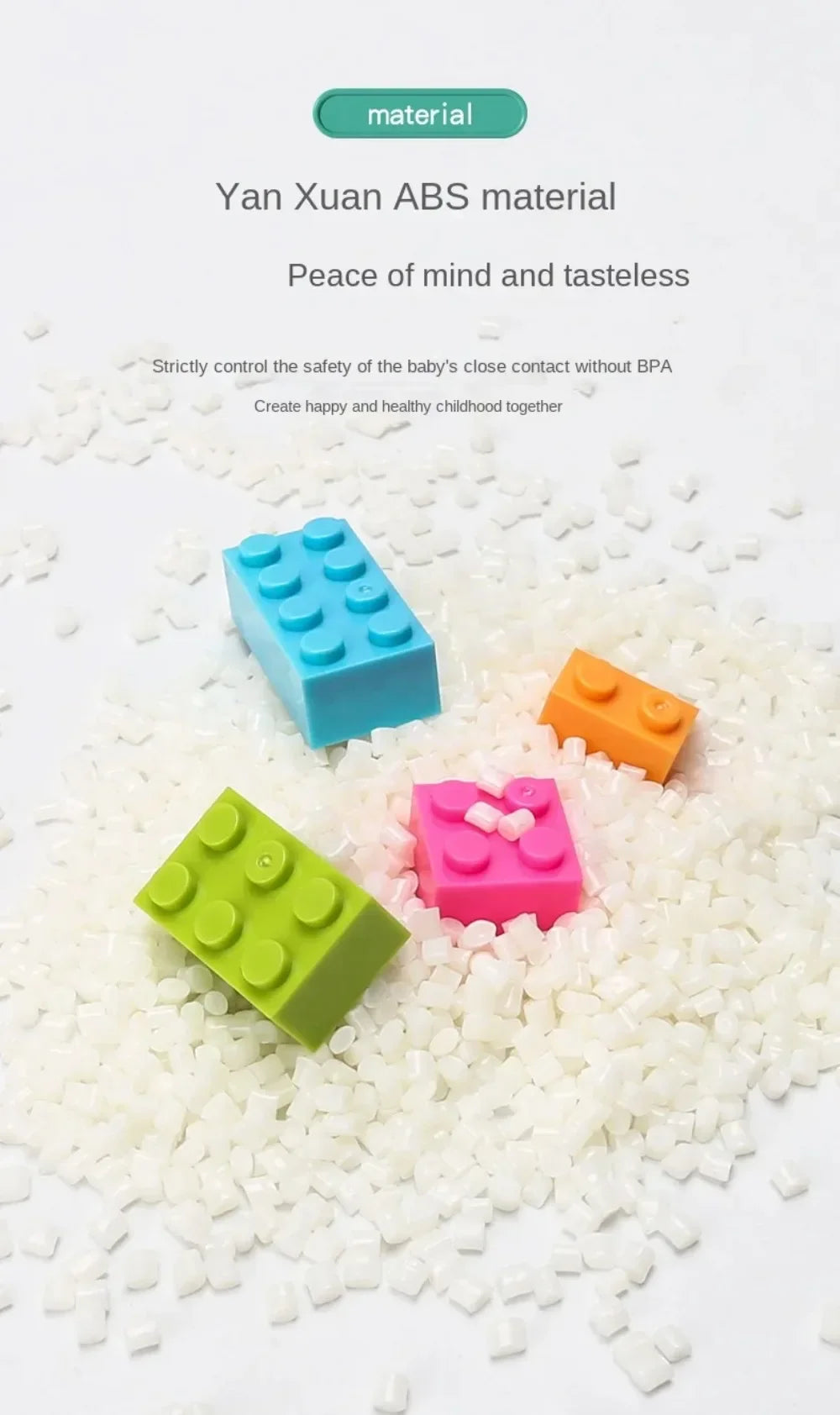 A pile of white building blocks with various colored plastic pieces including blue, orange, and green blocks.