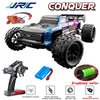 A black and purple 1:14 scale RC monster truck with large tires and a brushless motor, along with a remote control transmitte
