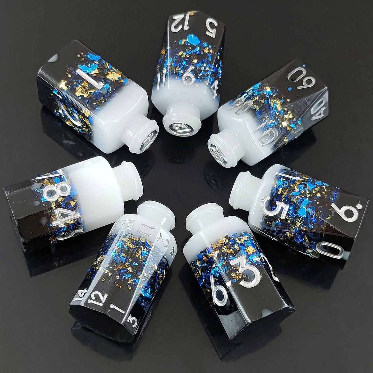 A set of seven floral resin potion bottles shaped like polyhedral dice, featuring numbers 1 through 12.