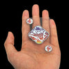 A hand holds several waterproof transparent playing cards, including a Joker and a King, on its palm.