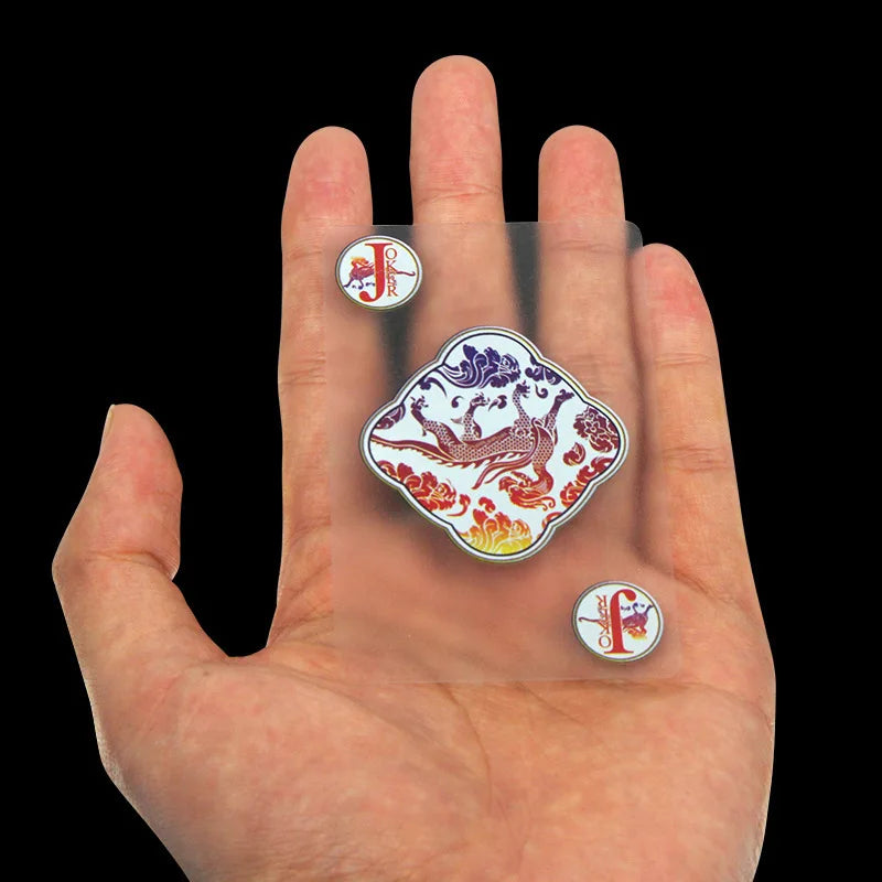 A hand holds several waterproof transparent playing cards, including a Joker and a King, on its palm.