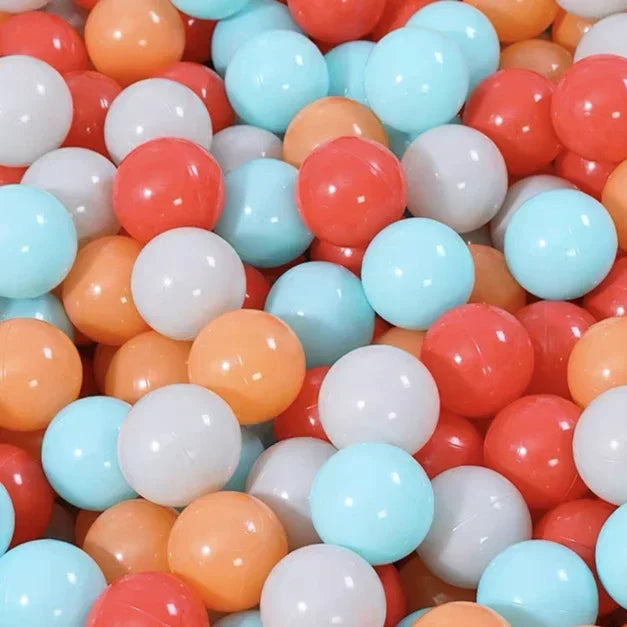 A close-up view of a large pack of colorful plastic balls in various shades of orange, pink, white, and light blue.