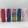 A set of colorful 3D printed spike roller fidget toys stacked in a row.