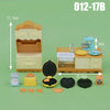 A dollhouse furniture playset featuring a kitchen sink, countertop, and storage cabinet in light beige colors.