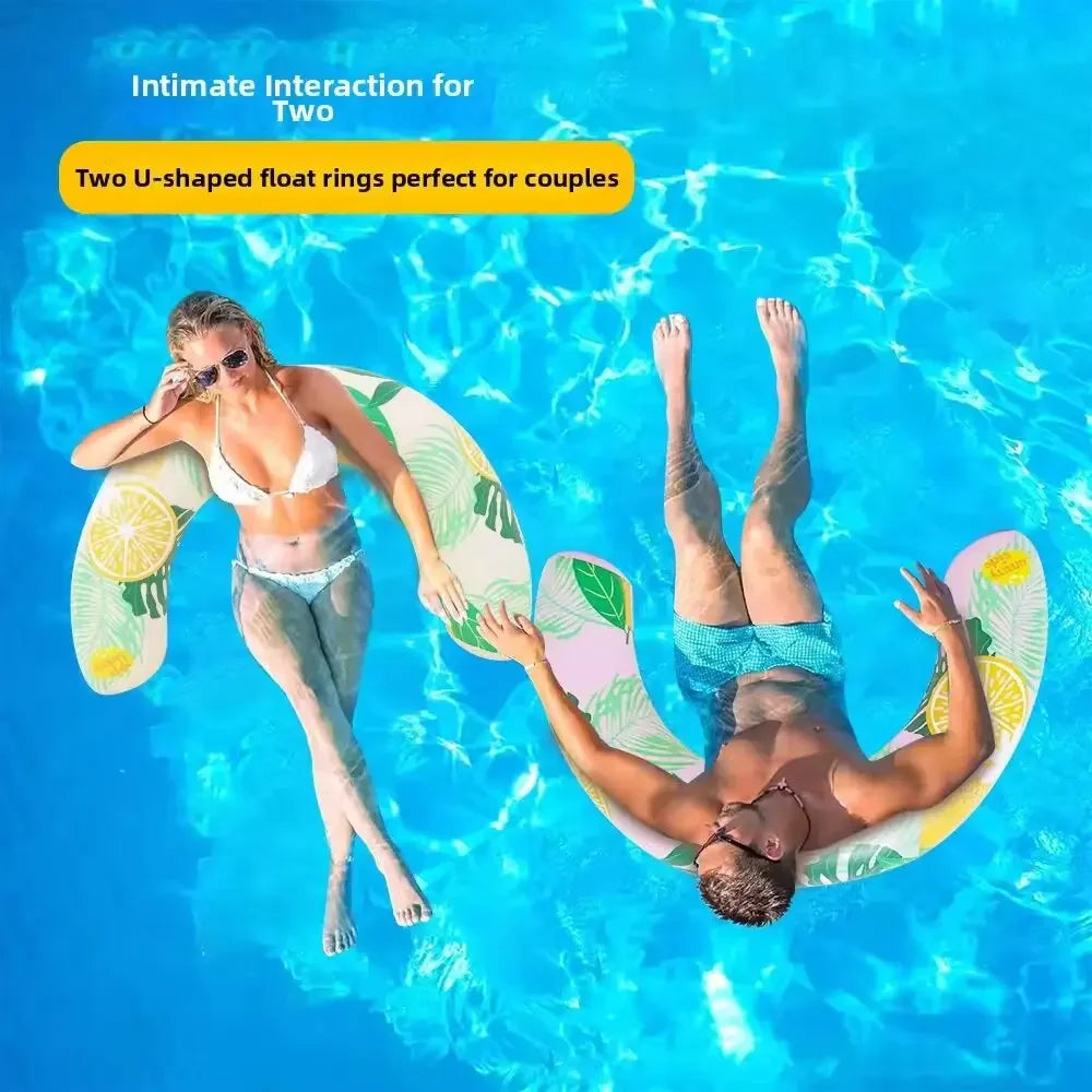 A couple floating in blue water using two U-shaped inflatable swim rings for intimate interaction.