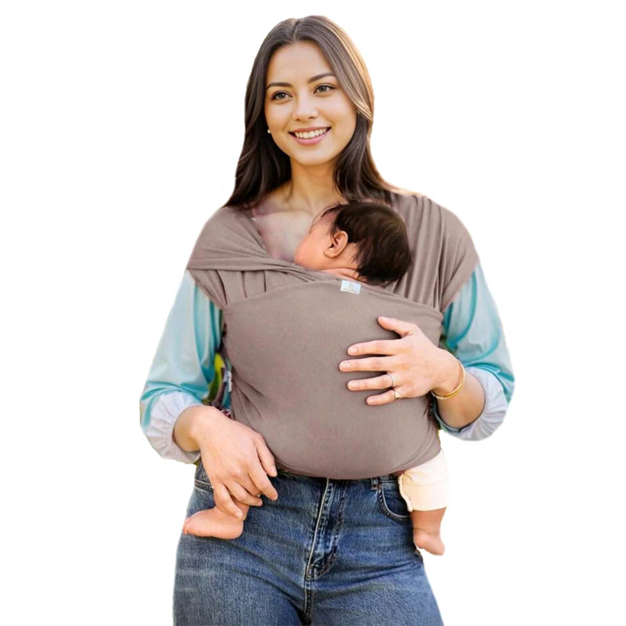 A woman is holding a baby in a brown knitted fabric multi-functional baby carrier.