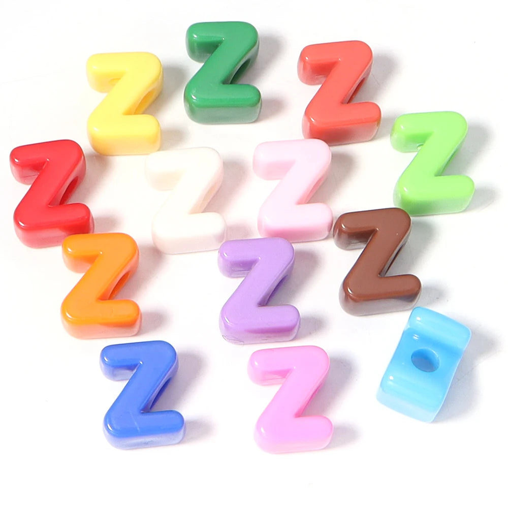 A collection of colorful acrylic alphabet beads shaped like the letter Z arranged in a circle.