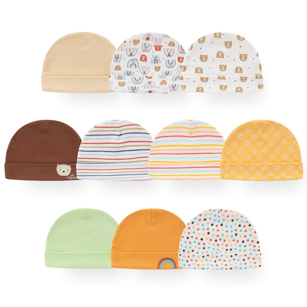 A collection of cute cartoon baby hats in various colors and patterns including beige brown white yellow orange and green.
