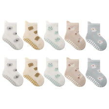 A pack of five pairs of non-slip cartoon socks featuring various cute animal faces and designs in white, beige, and light blu