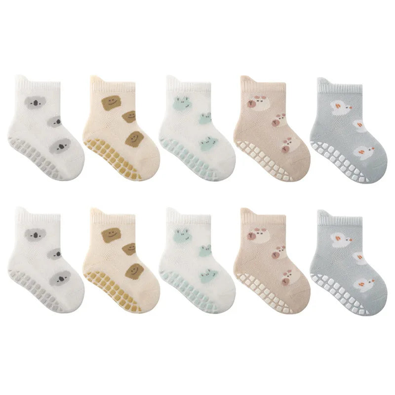 A pack of five pairs of non-slip cartoon socks featuring various cute animal faces and designs in white, beige, and light blu
