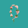A handmade strawberry crochet headband in pink and green yarn against a teal background.