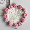 Hand-crocheted pink and green lily of the valley coasters with a white center