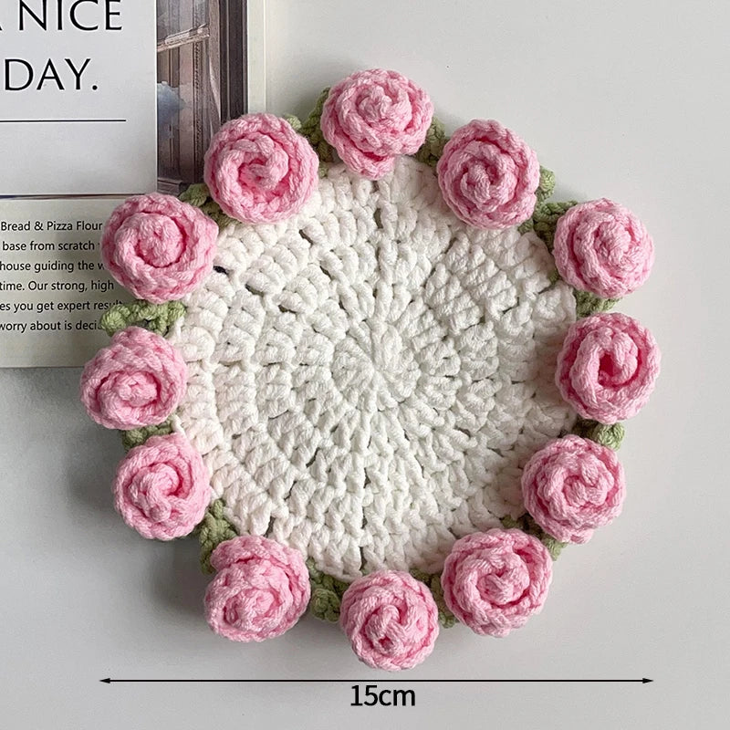 Hand-crocheted pink and green lily of the valley coasters with a white center
