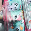 A set of three small, colorful plastic animal figures resembling mice or similar creatures is shown in packaging.