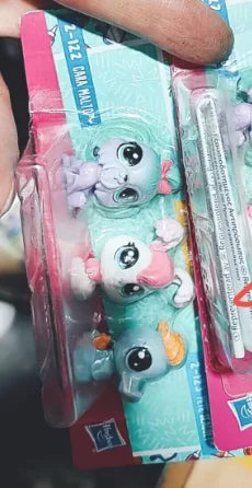 A set of three small, colorful plastic animal figures resembling mice or similar creatures is shown in packaging.