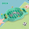 A green tabletop foosball game is shown with a soccer ball in motion, being played on a light green surface.