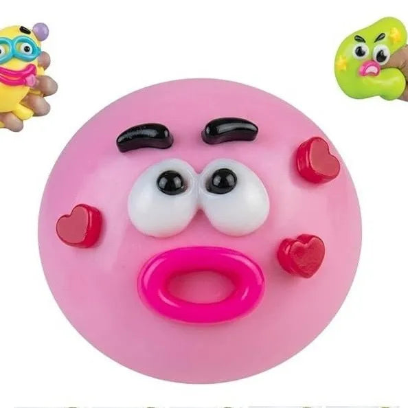 Jouet squishy rose en forme de visage de chien avec de grands yeux et une langue.
