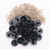 A pile of black plastic safety eyes with washers for crafting and stuffed animals