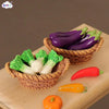 A miniature dollhouse vegetable basket play set filled with colorful bell peppers and a pumpkin.