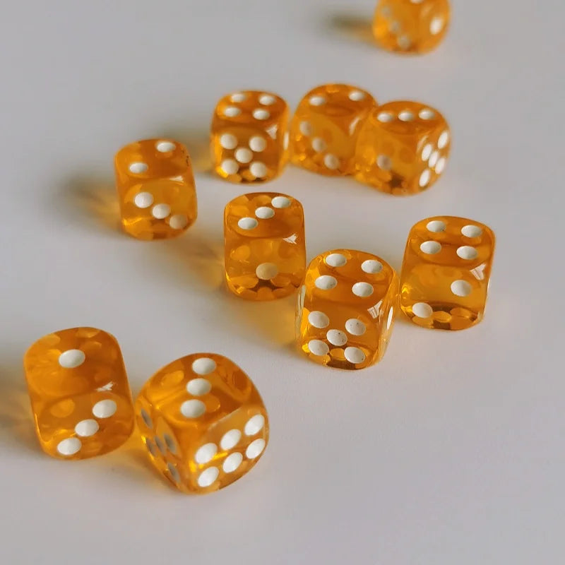 A collection of bright orange transparent dice scattered on a white surface.