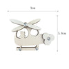 A wooden DIY Montessori busy board shaped like a stylized airplane or aircraft for sensory learning.