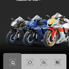 A diecast model of the Yamaha YZF-R1M motorcycle in white, blue, and yellow colors.