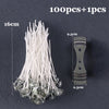 A bundle of white pre-waxed cotton candle wicks with metal sustainers shown next to a measuring scale.